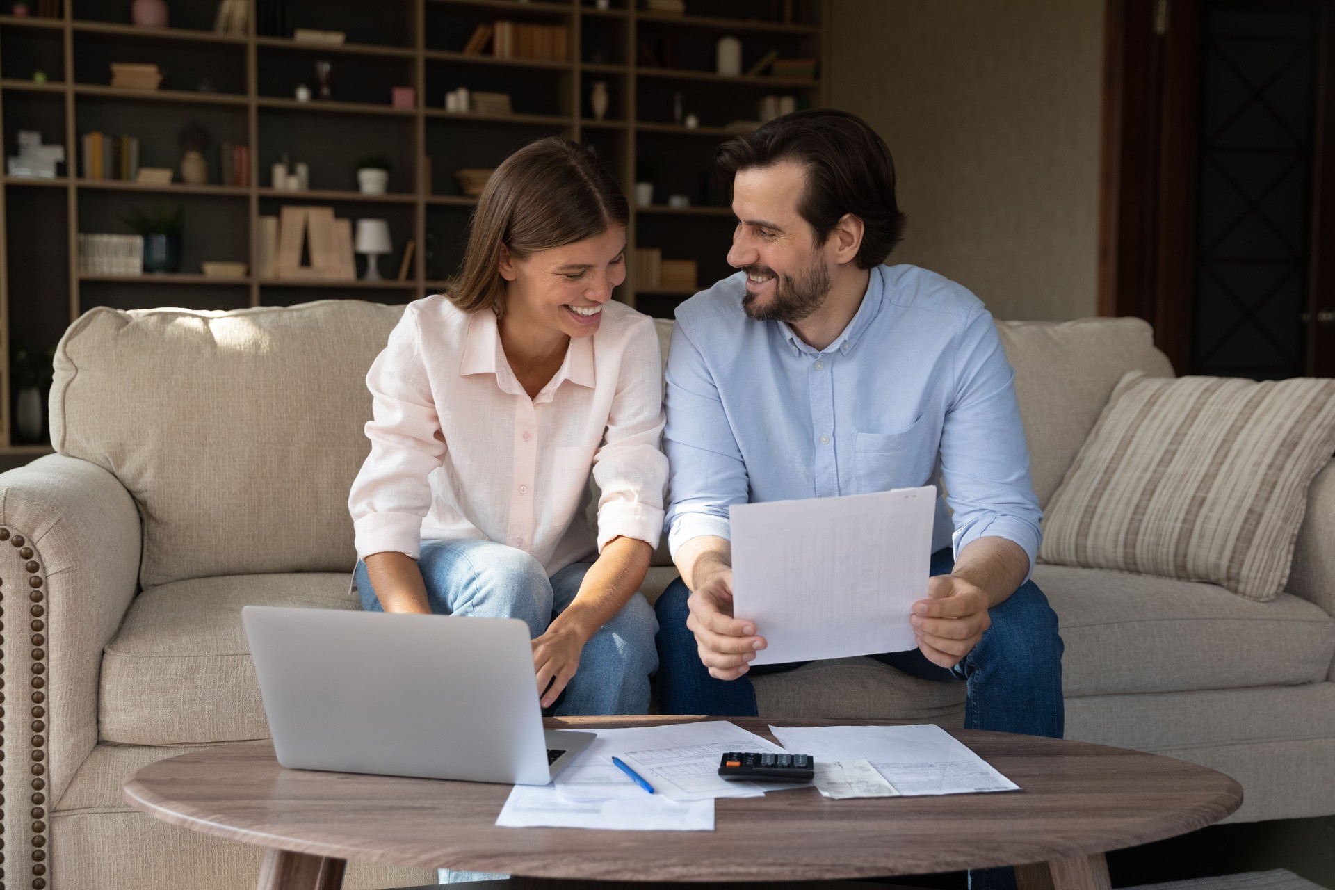 Happy couple doing domestic paperwork